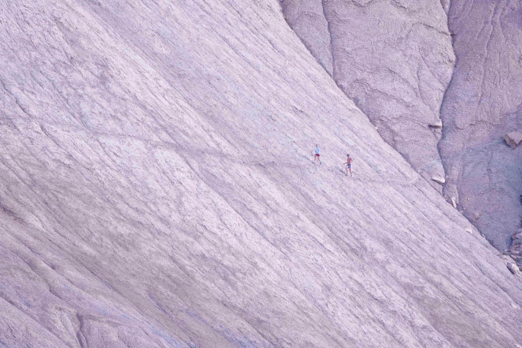 Runners contour their way across the steep hillside