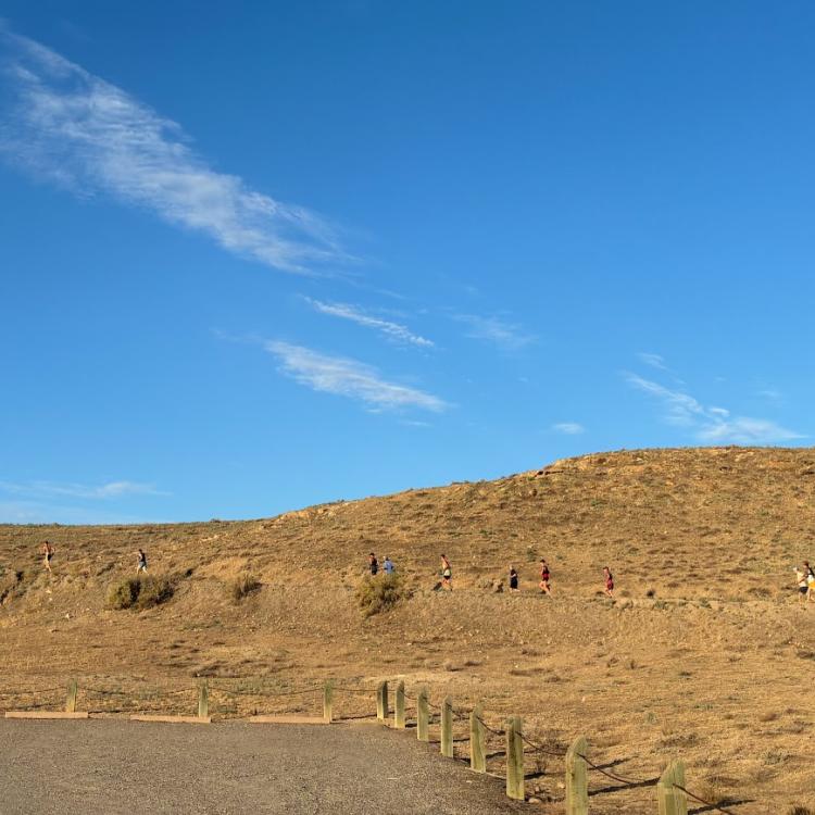 Line of participants cresting the hill on Hawkeye Rd